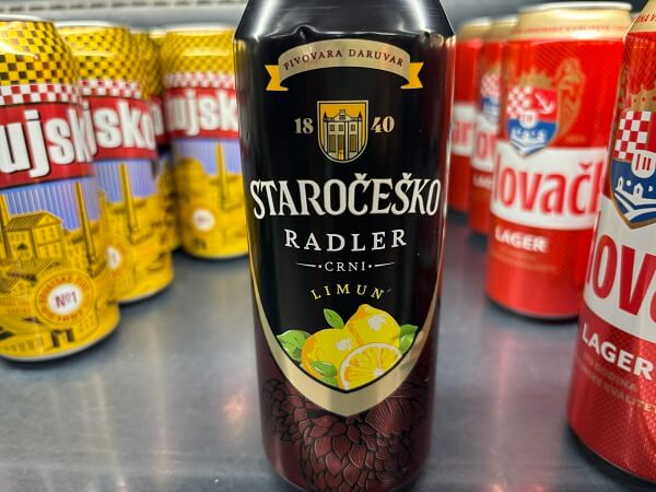クロアチアのショップの棚に並ぶ、黒地にレモンのイラストが描かれたStaročeško Radler（ラドラー）の缶